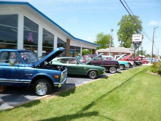 Multiple cars parked outside a dealership